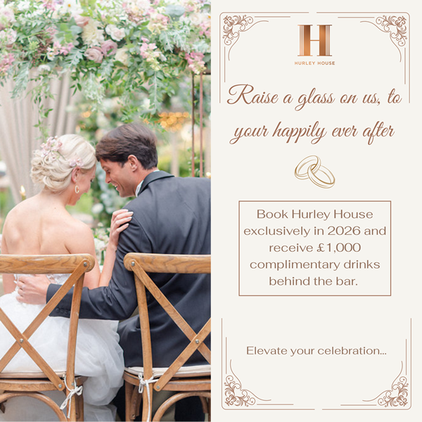 Hurley House - A bride and groom sit closely together at an outdoor wedding reception, smiling under a floral arch. Beside them, a promo offers £1,000 in complimentary drinks for 2026 bookings at Hurley House.